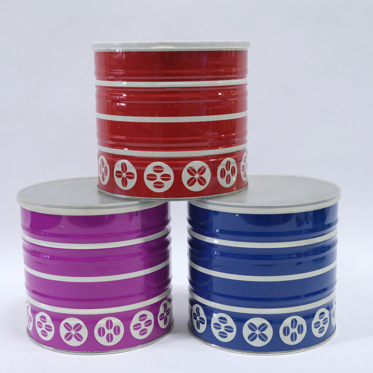 THREE TIN COFFEE CANS, 1960S/70S.