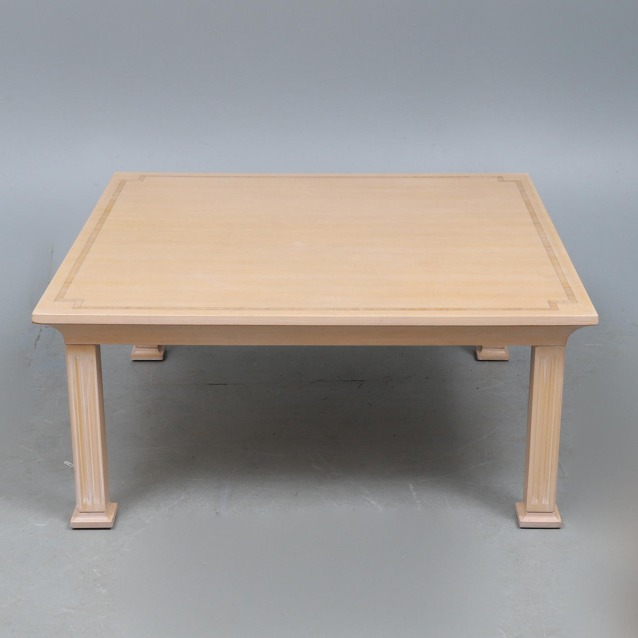 A CONTEMPORARY BLONDE WOOD LOW CENTRE TABLE.