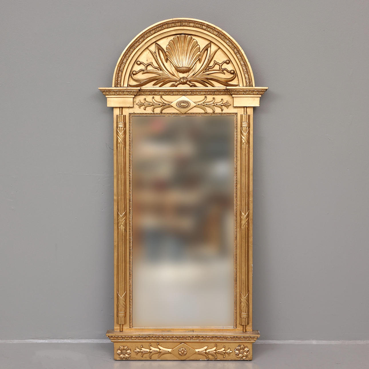 An empire wall mirror, 19th century.