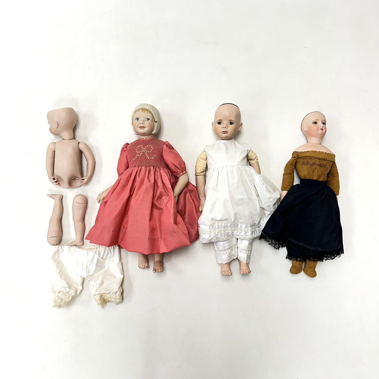 FOUR BISQUE DOLLS.