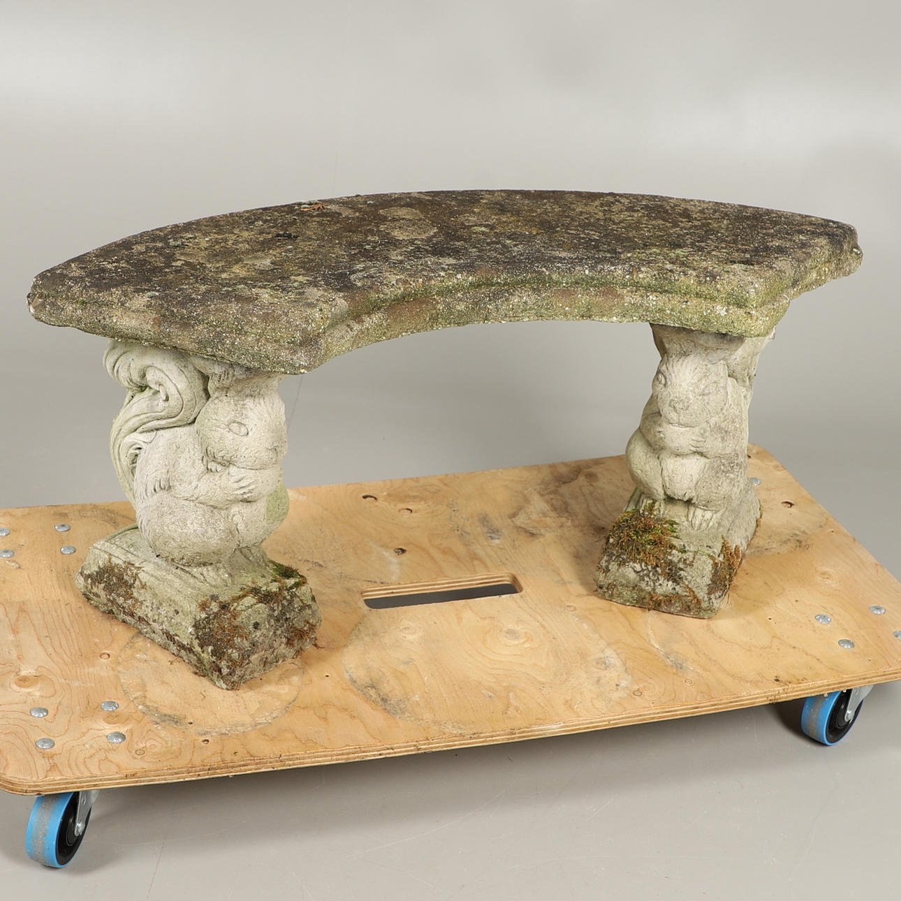 A RECONSTITUTED STONE GARDEN BENCH.