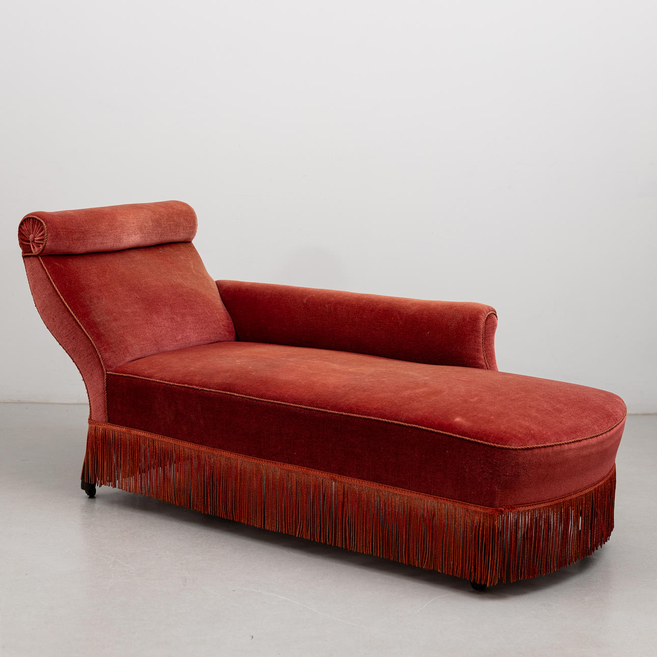 A plush upholstered divan, circa 1900.