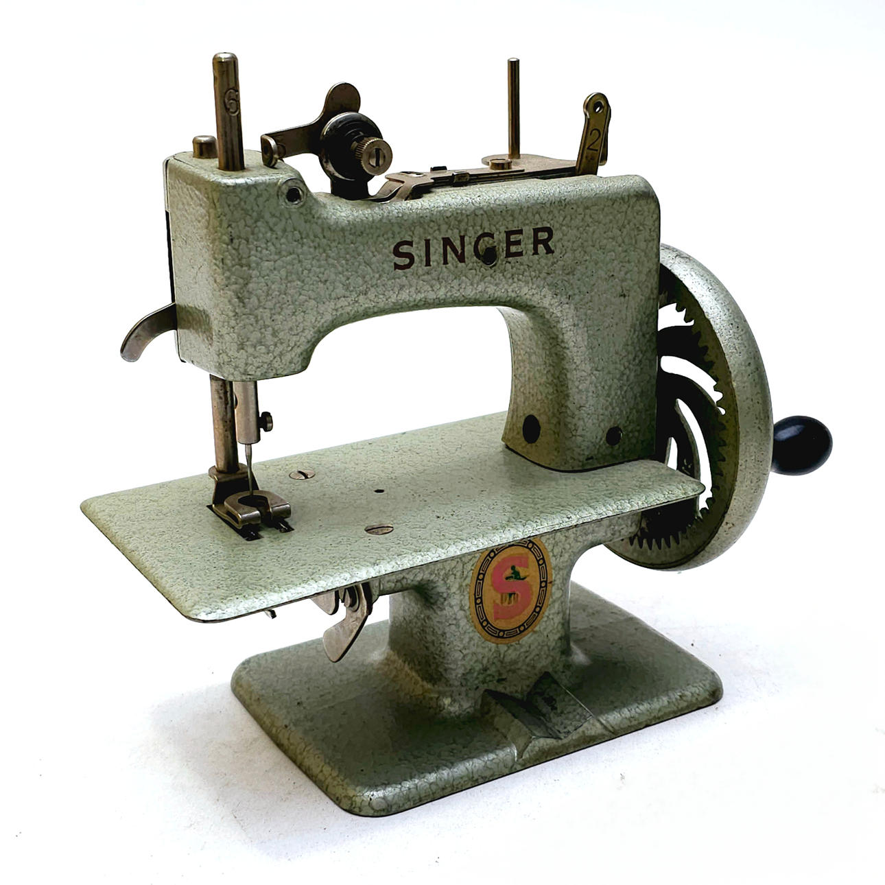 MINIATURE SEWING MACHINE IN OPERATION.