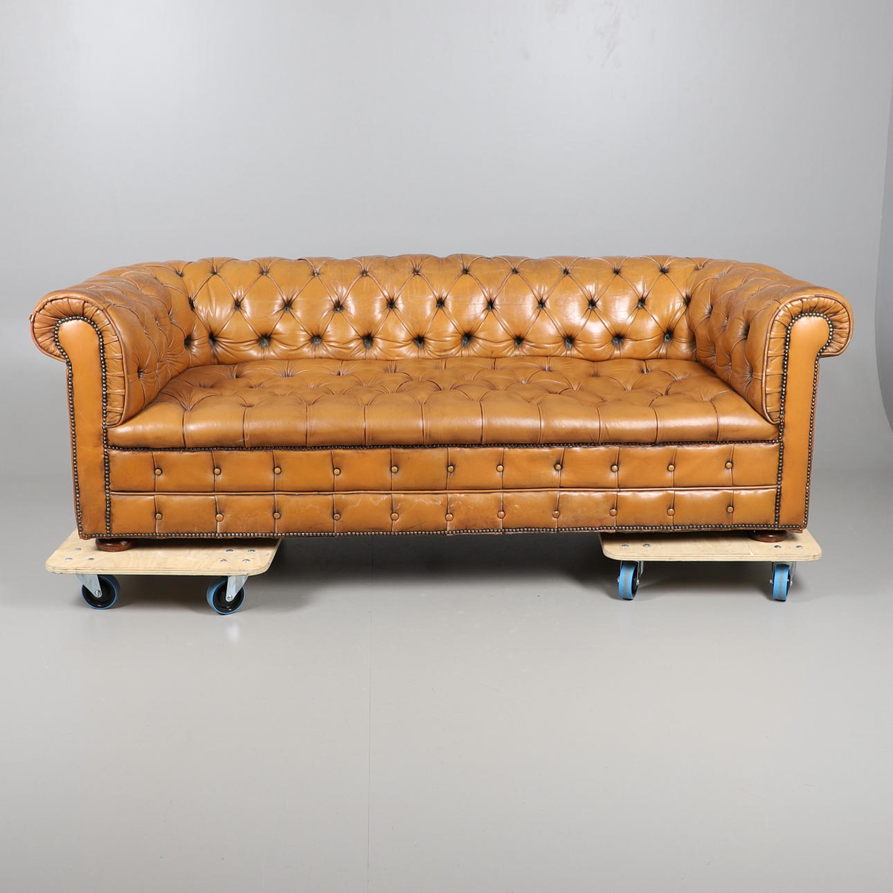 A LARGE TAN LEATHER CHESTERFIELD SOFA.