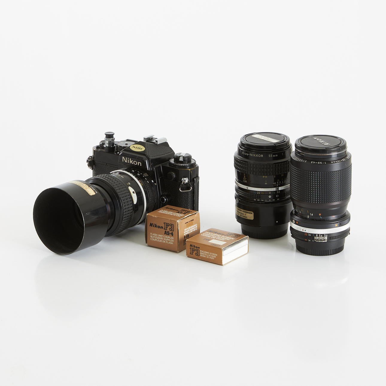 NIKON FE, camera, as well as three lens.