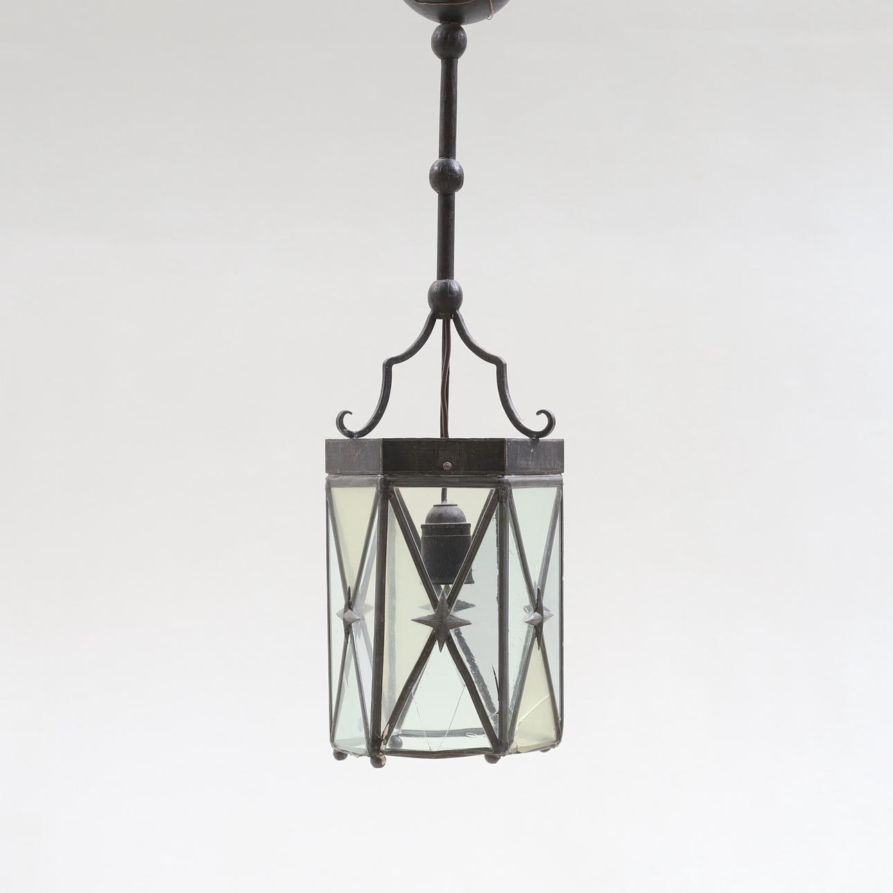 A 20th-century wrought ceiling lamp.