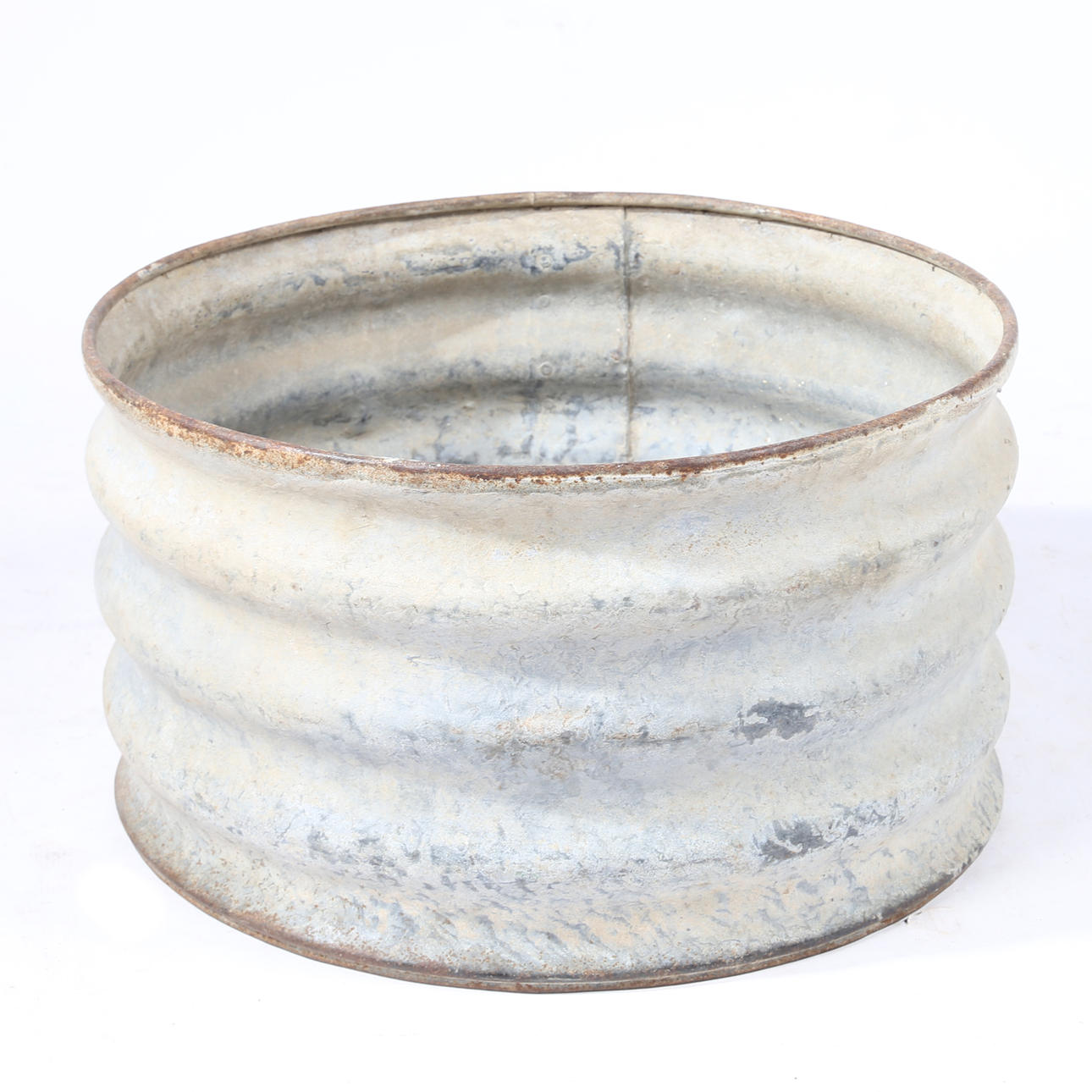 A GALVANIZED TROUGH OF CIRCULAR FORM.