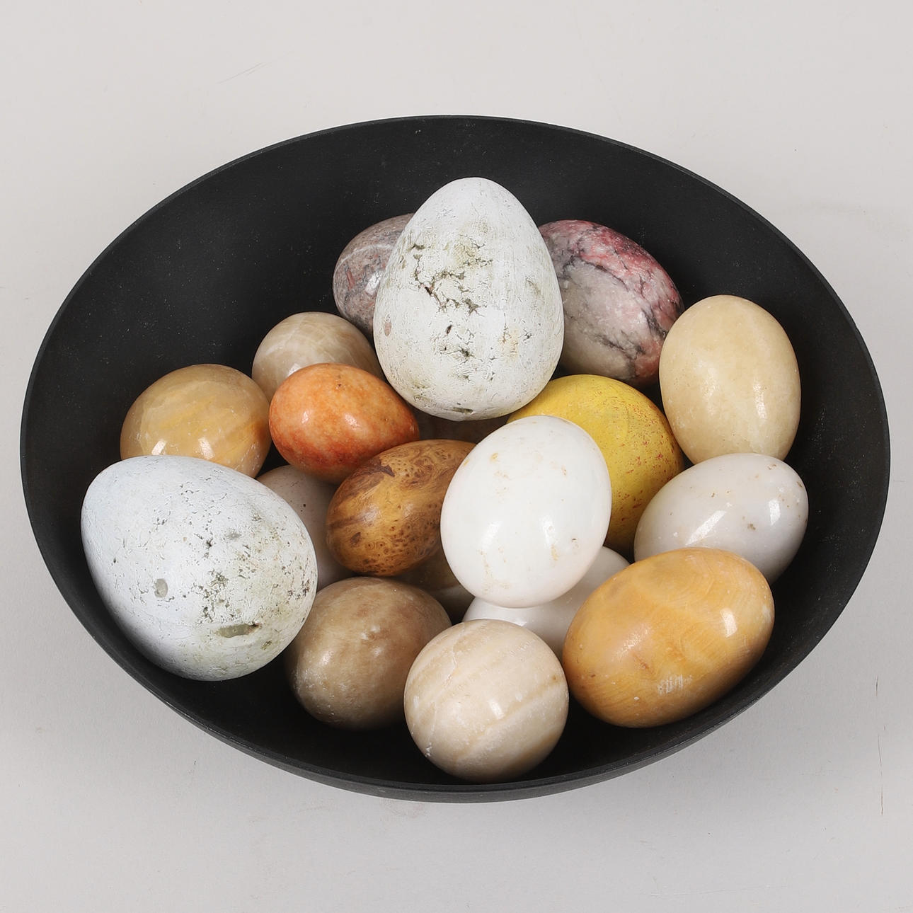EGGS & FRUIT, 19 pcs. in bowl, mostly stone.