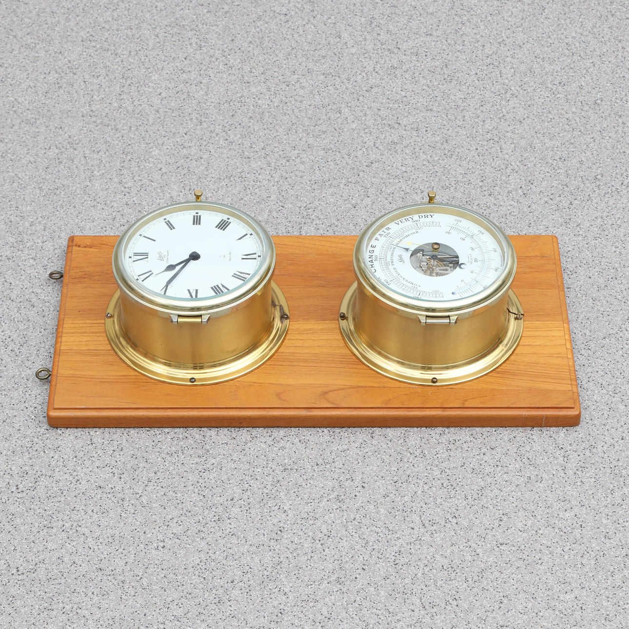 SCHATZ, SHIP CLOCK AND BAROMETER. Brass housings, mounted on teak