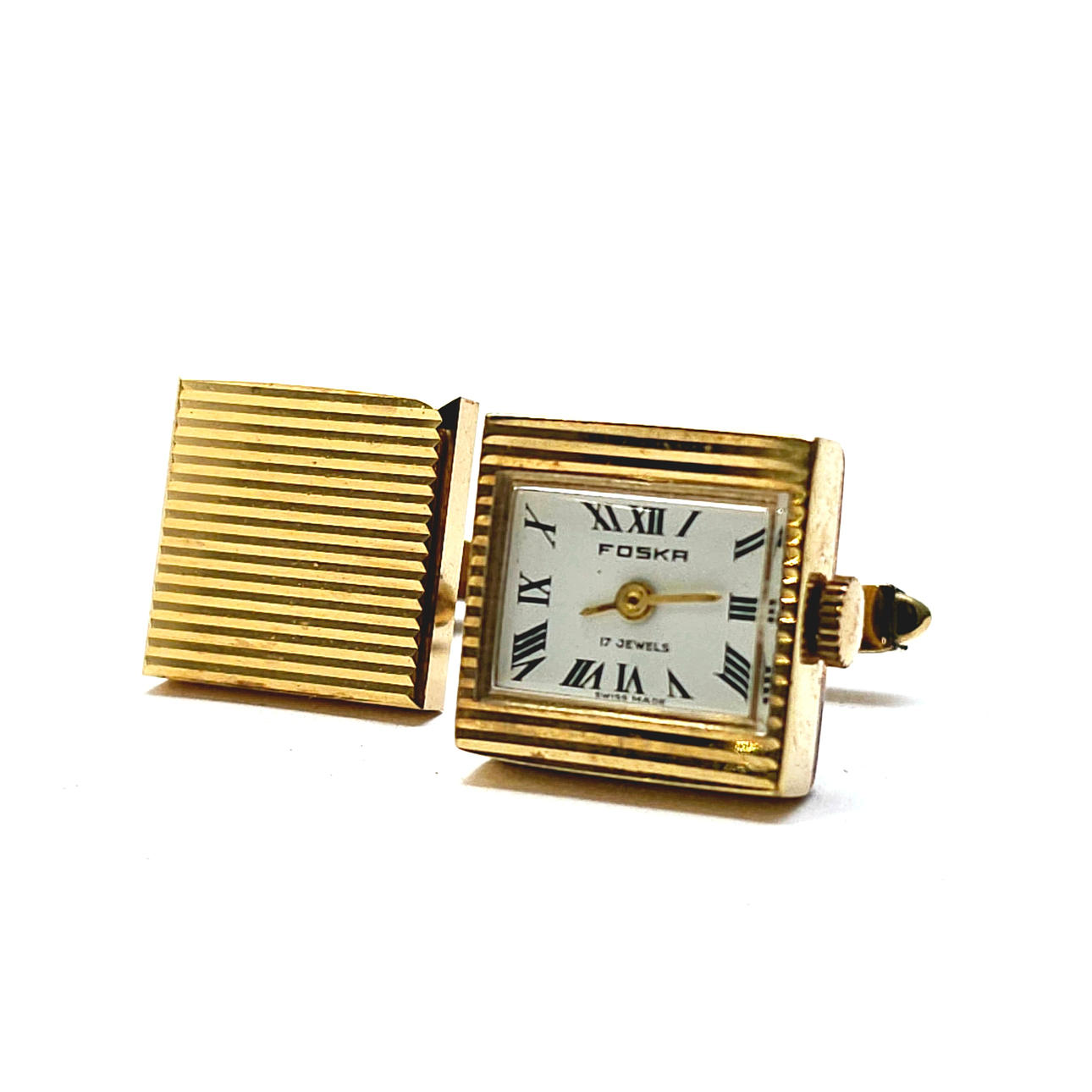 UHRENÄHNLICHE MANSCHETTENKNÖPFE AUS GOLDFARBENEM METALL.