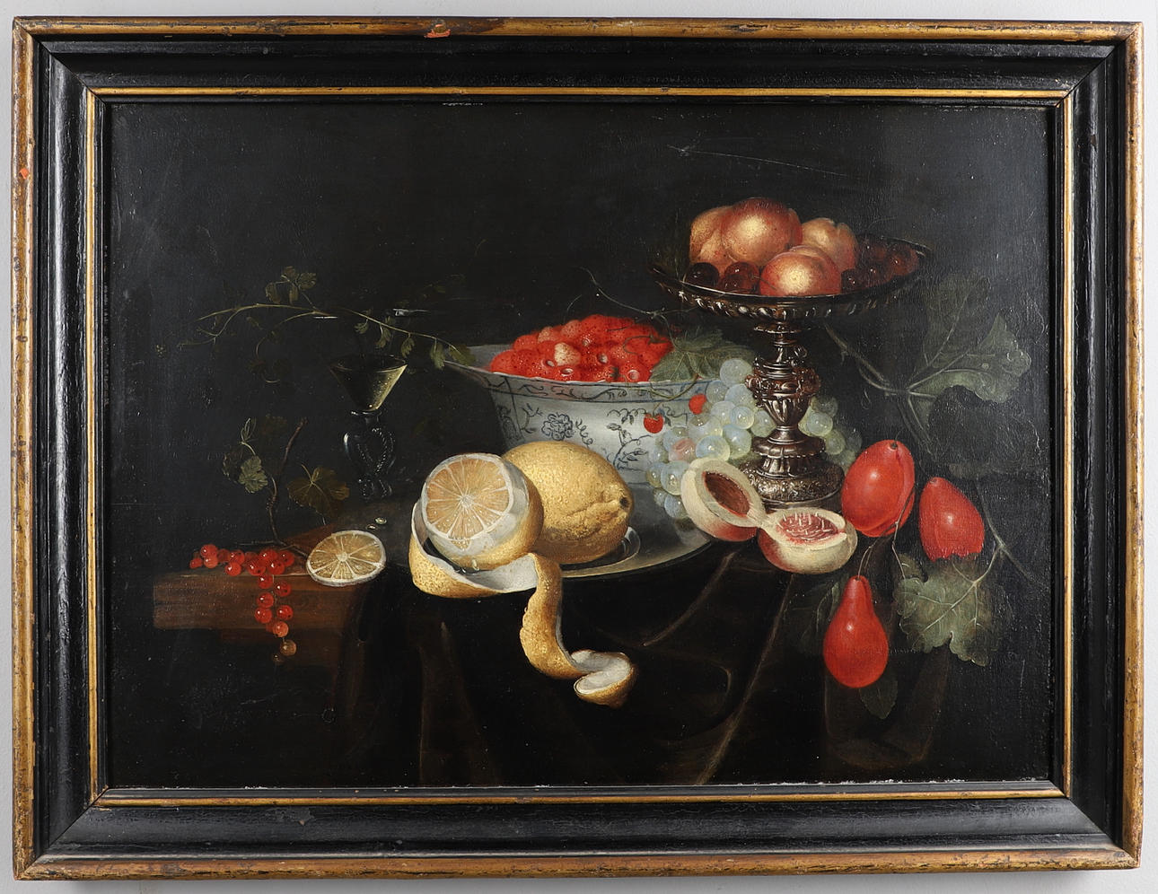 CIRCLE OF PIETER DE RING (1615-1660). STILL LIFE WITH A SILVER TAZZA, A PORCELAIN BOWL AND A WINE GLASS, WITH STRAWBERRIES, PEACHES, PLUMS AND LEMONS.