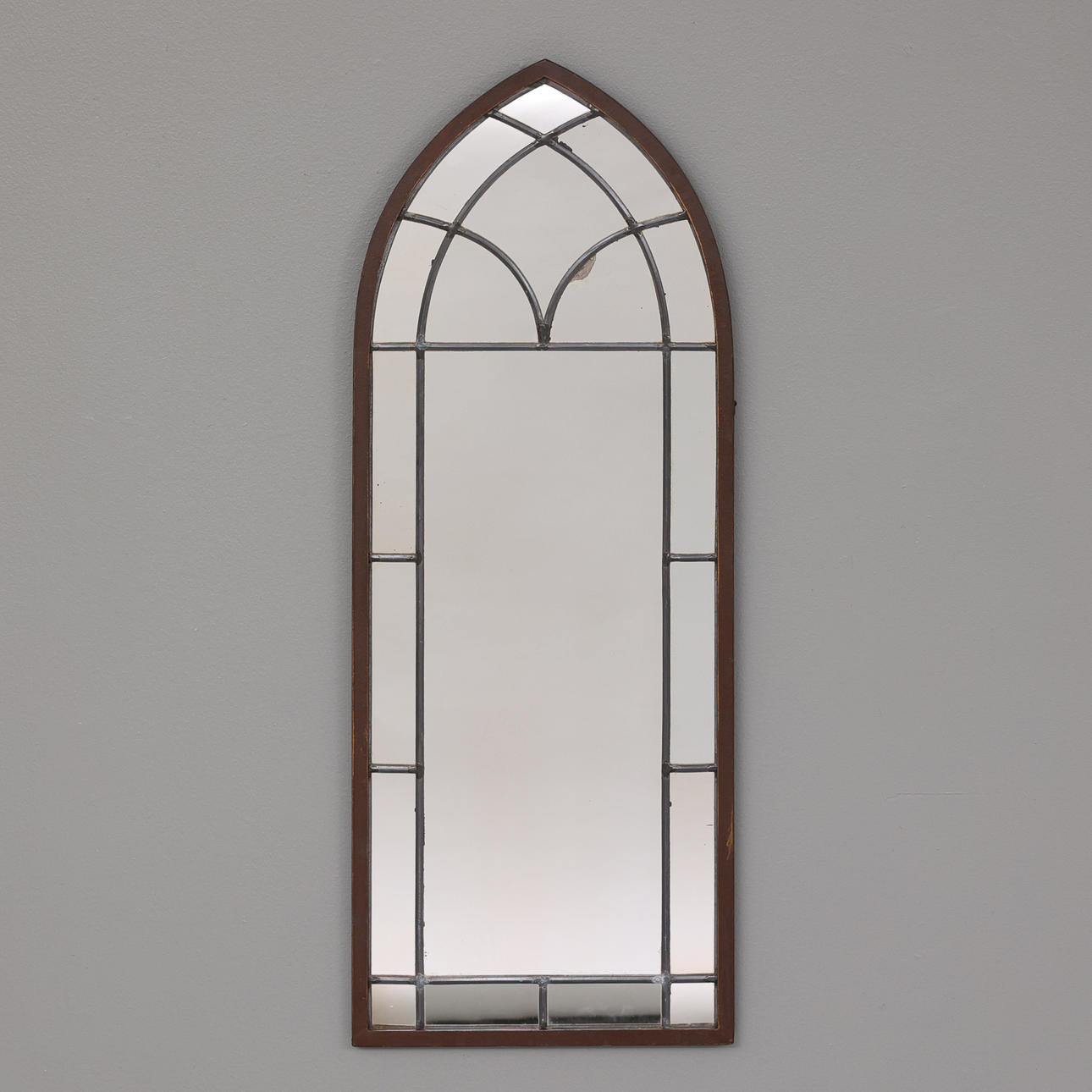 A metal wall mirror, mid 20th century.
