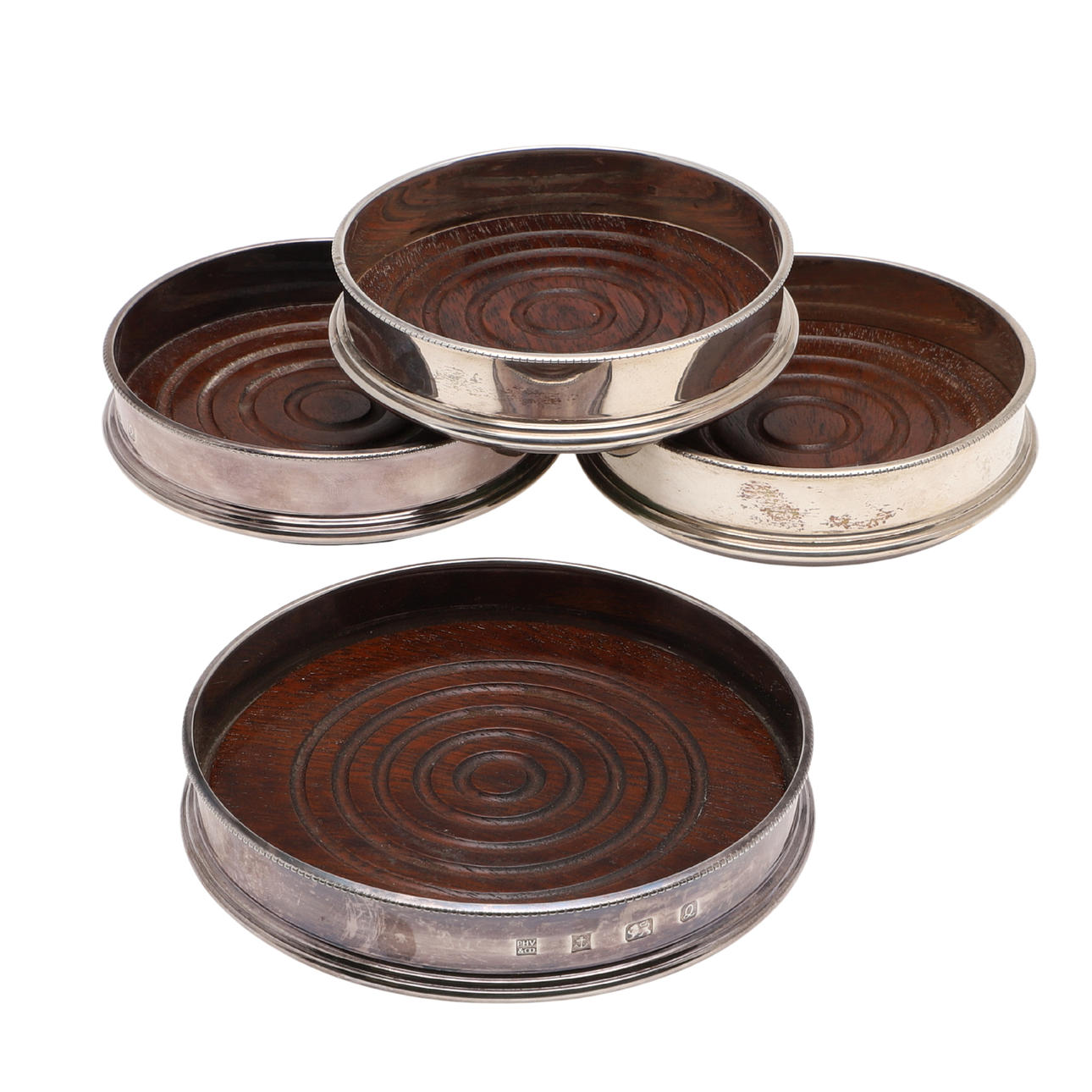 FOUR SILVER MOUNTED WINE COASTERS.