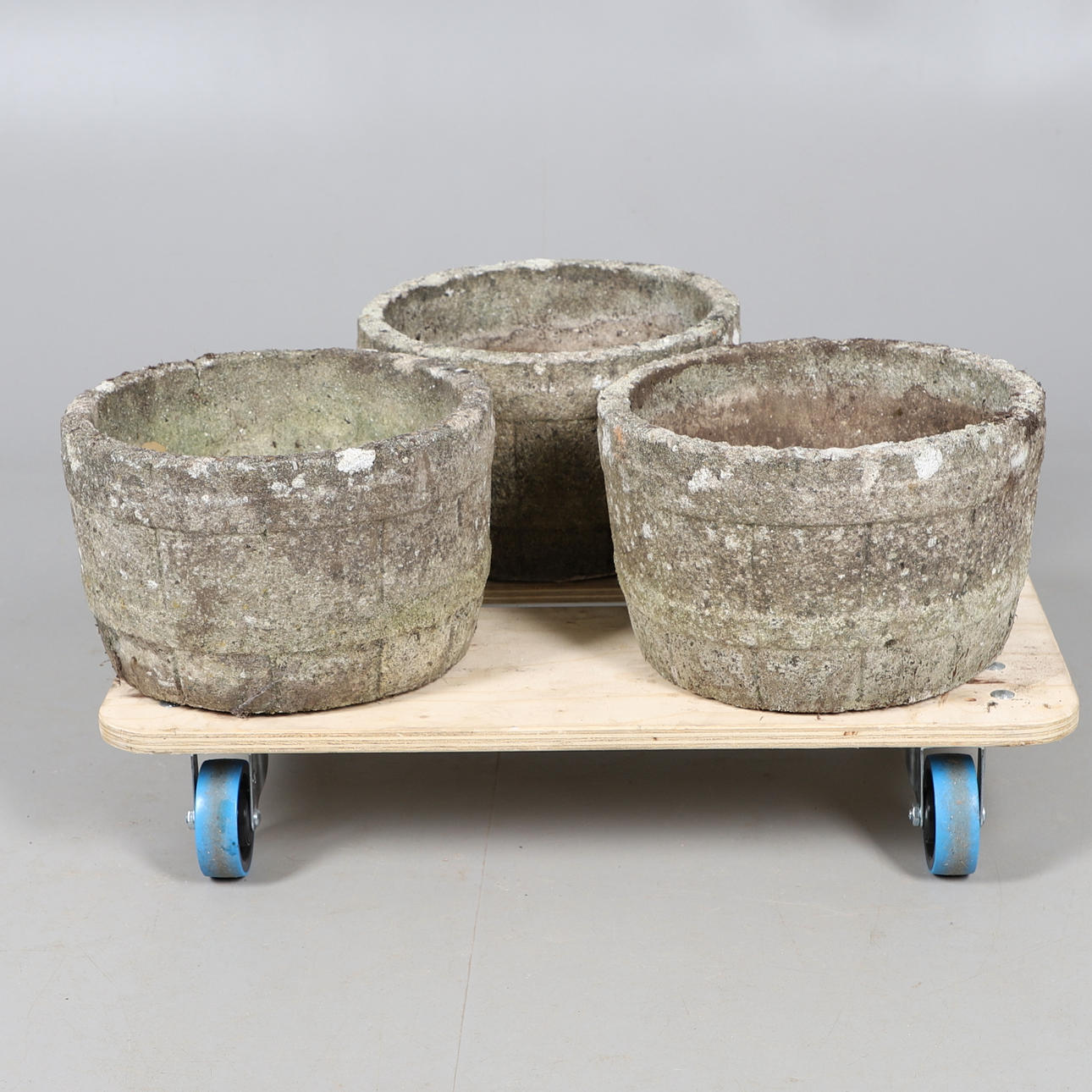 A TRIO OF RECONSTITUTED STONE ROUND PLANTERS.