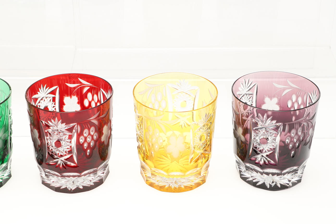 ELEVEN LARGE COLOURED CUT GLASS TUMBLERS. Glass Tableware