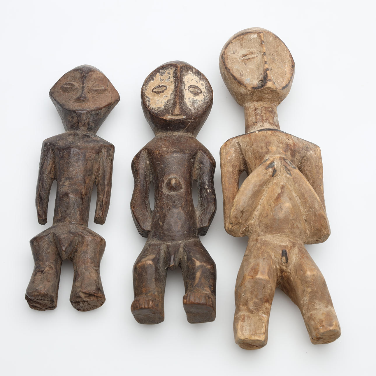 Three wooden figurines, Lega, Congo.