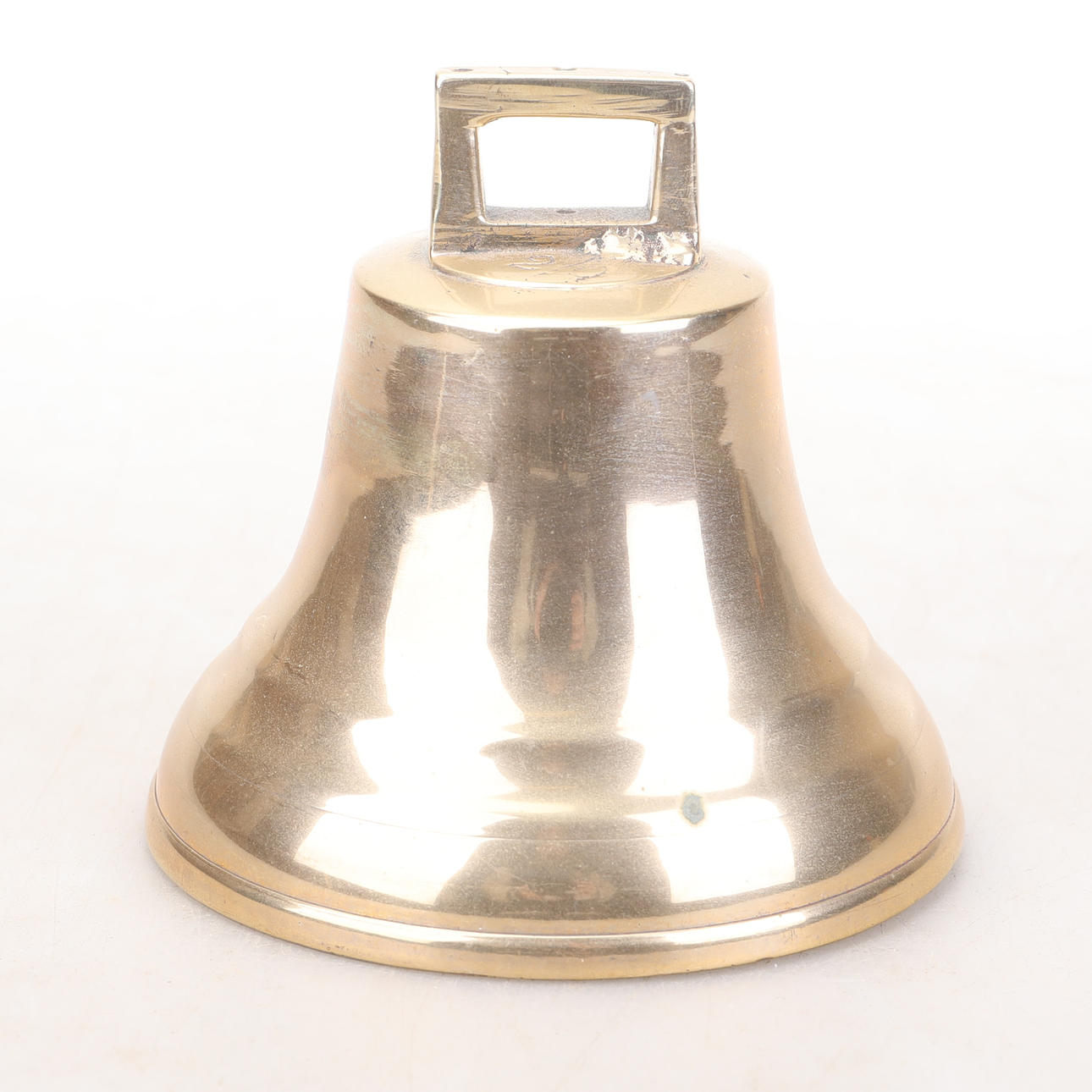 A brass ship bell, marked E.M. Mora.