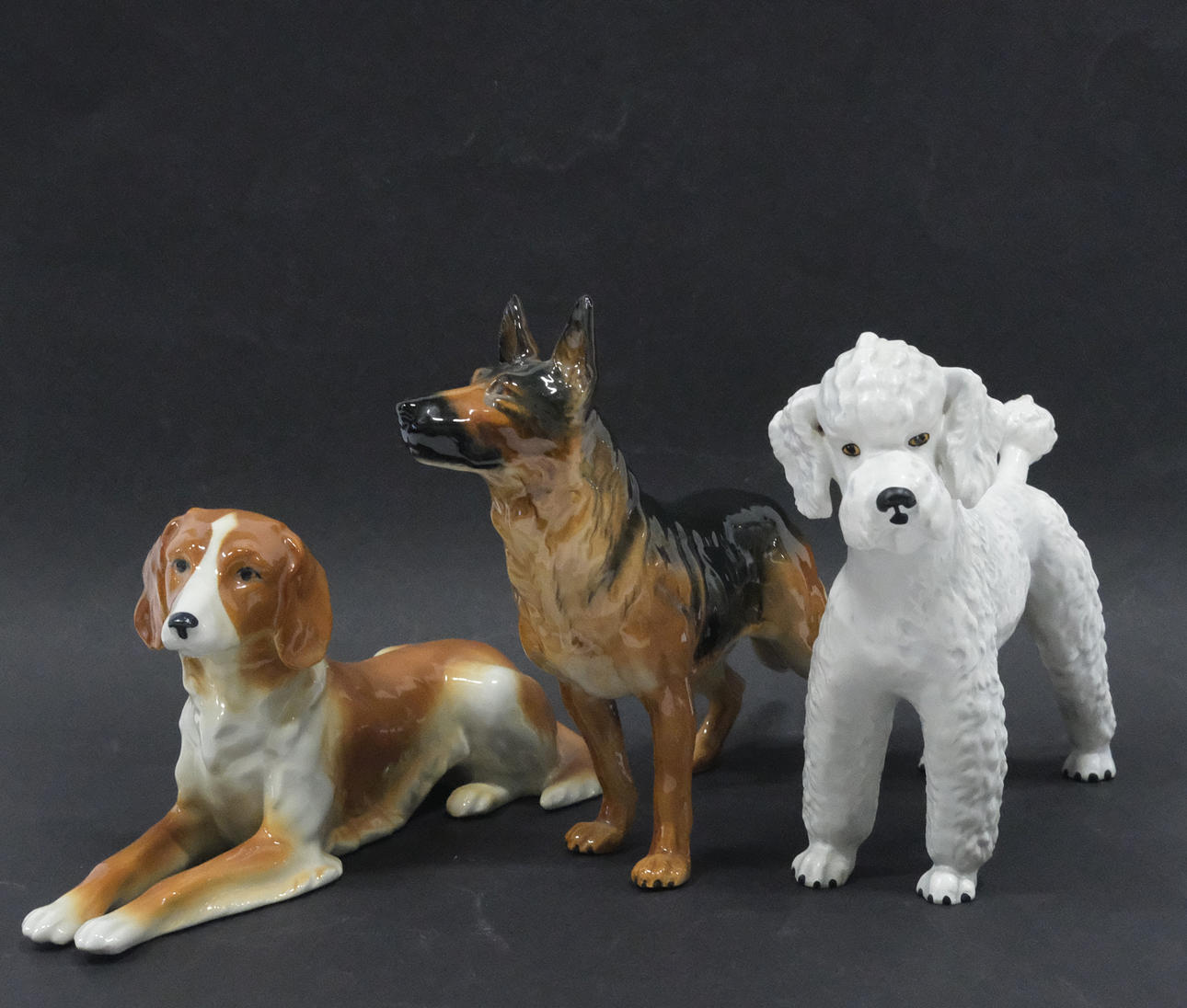 THREE DOG FIGURINES. GOEBEL AMONG OTHERS.