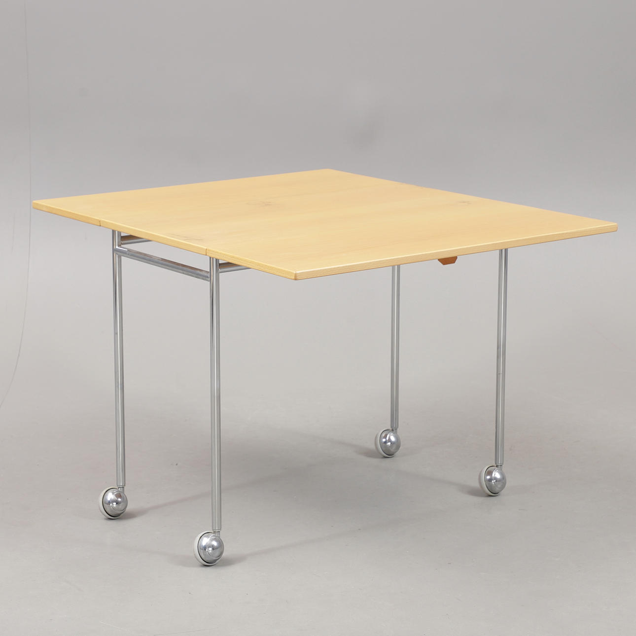 BRUNO MATHSSON. Folding table on wheels, “Berit”, chromed leg stand, Mathsson international, Värnamo, labeled.