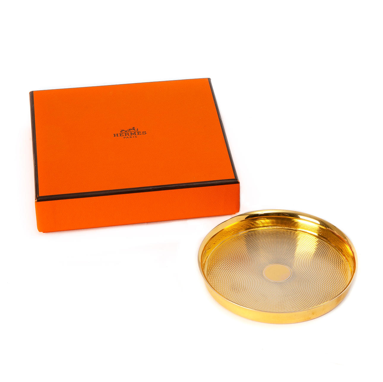 Ein HERMÈS-Untersetzer aus vergoldetem Silber.