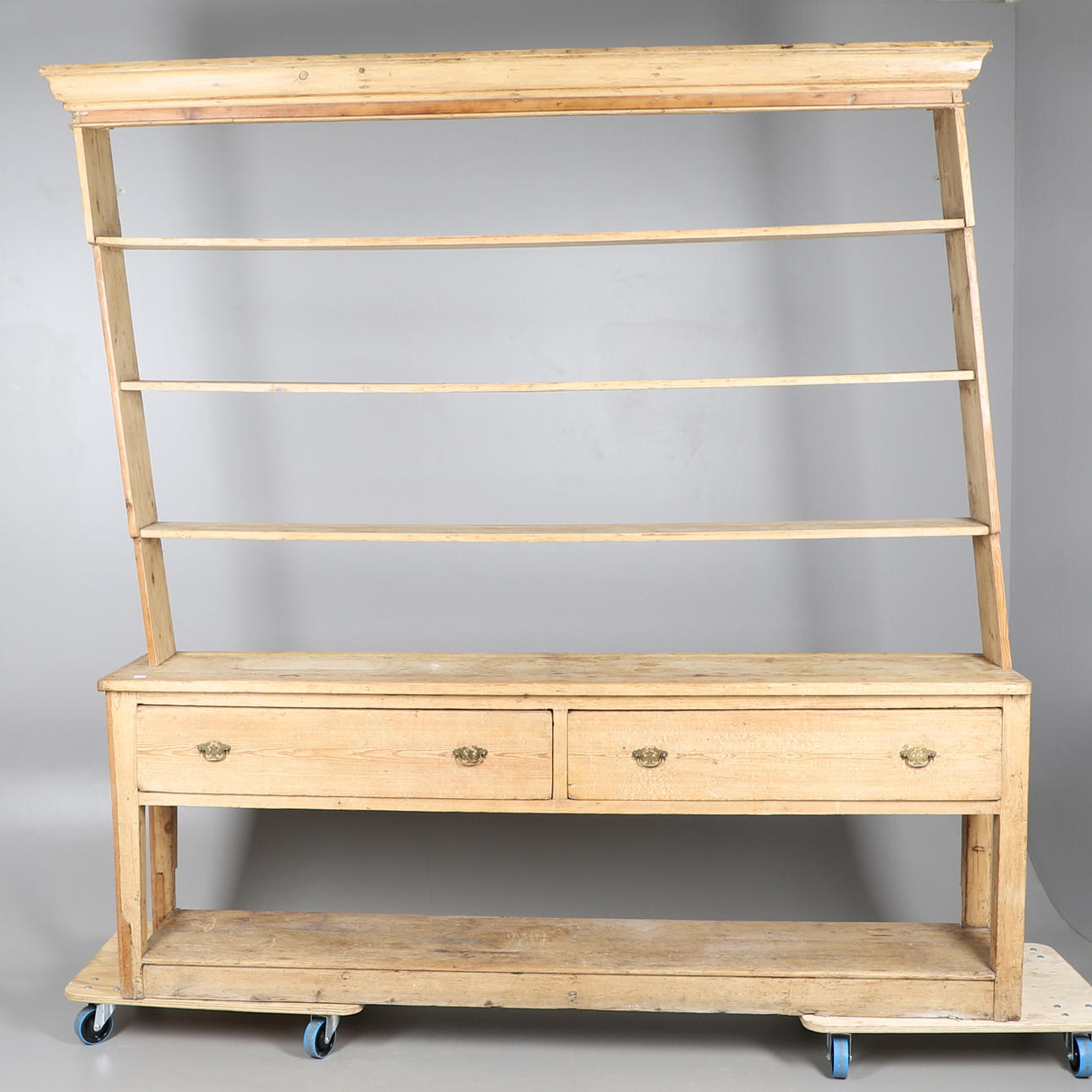 A LARGE VICTORIAN STRIPPED PINE KITCHEN DRESSER.