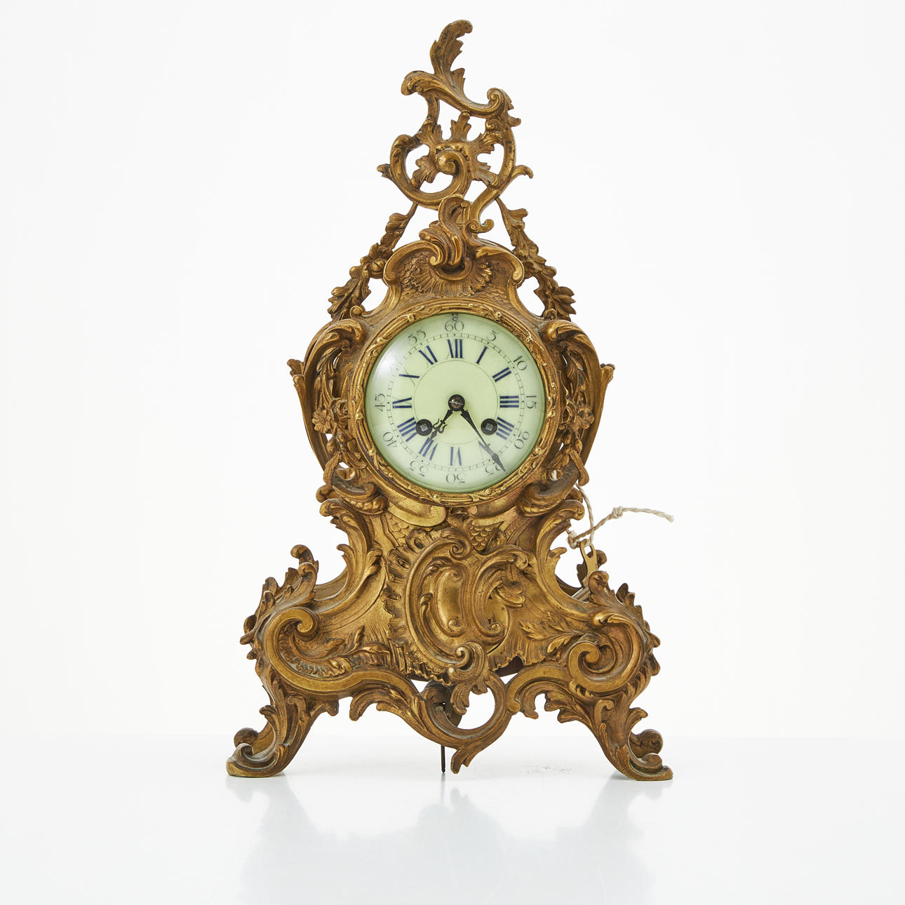 A rococo style table clock, brass case, dial with Roman numerals, 20th century.