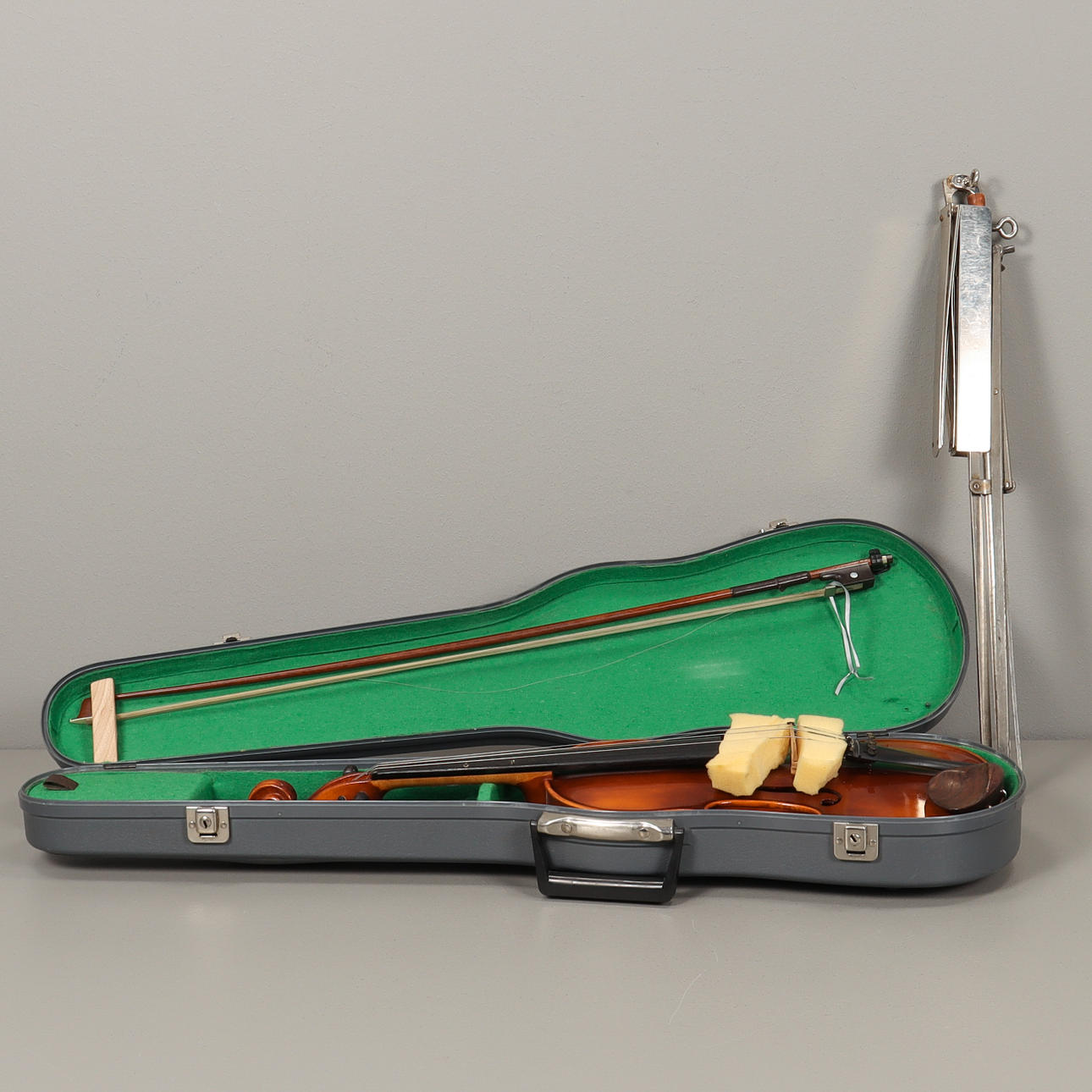 Violin with string and music stand.