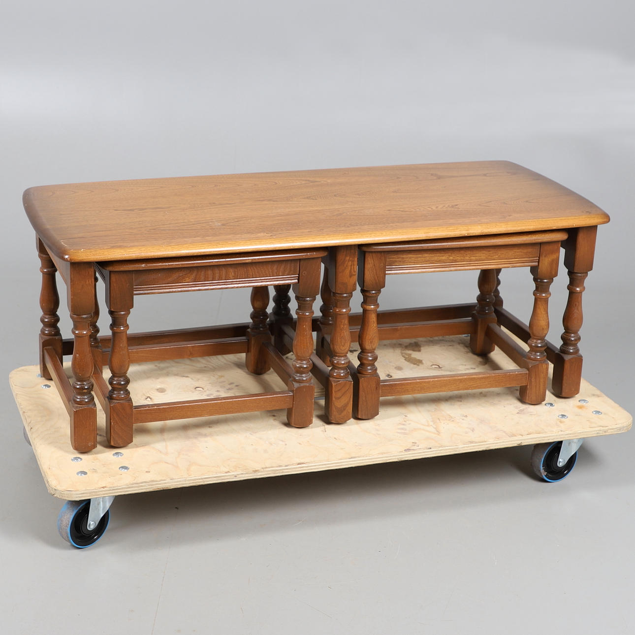 A MODERN ERCOL NEST OF THREE TABLES.