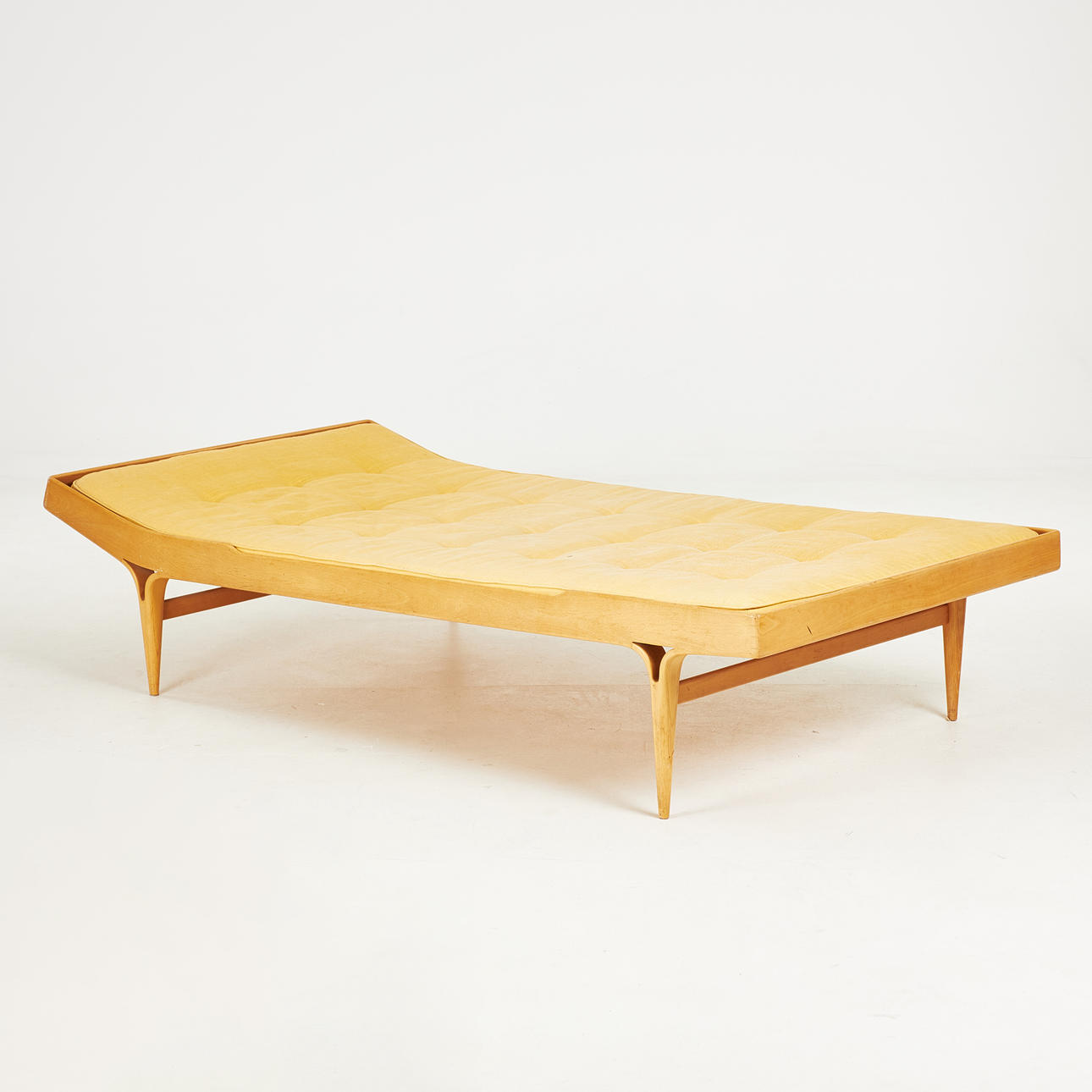 BRUNO MATHSSON. A daybed, “Berlin”, circa 1960s, beech frame, deep-stapled textile covered mattress, marked Bruno Mathsson Design, Made in Sweden.