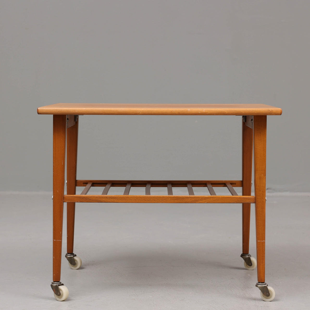 A wood table on wheels, mid 20th century.