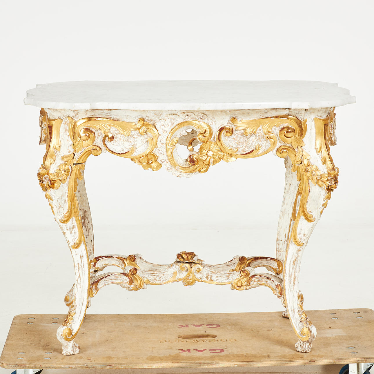A 19th century rococo style table with table, rococo style. undercarriage with cut decoration, partly gilt, white marble top.