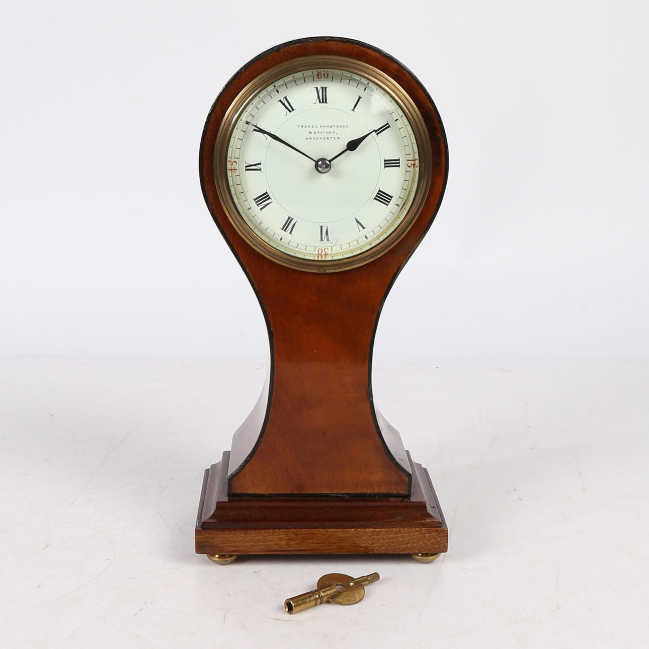 AN EDWARDIAN SATINWOOD BALLOON CLOCK.