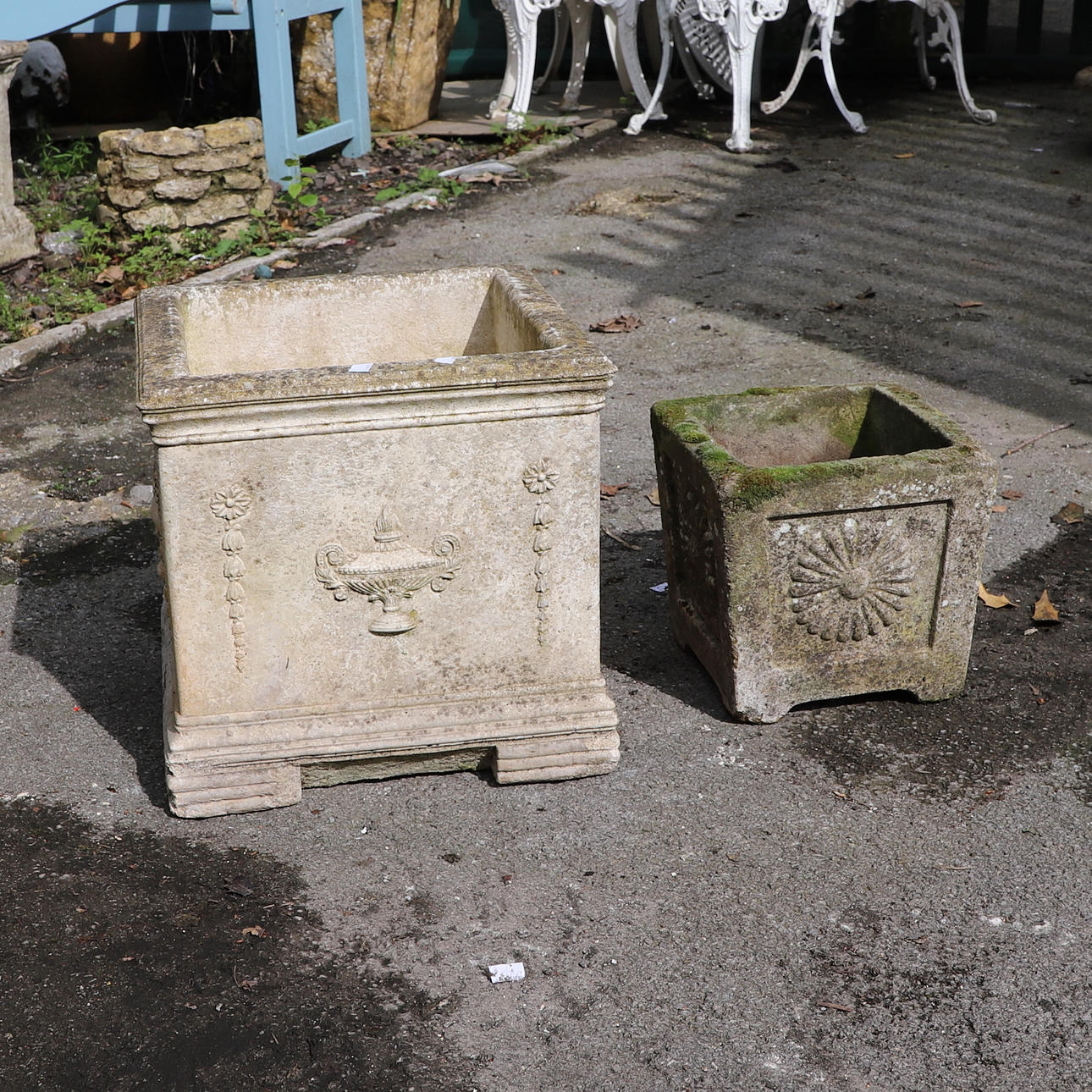 TWO RECONSTITUTED STONE SQUARE SECTION GARDEN PLANTERS.