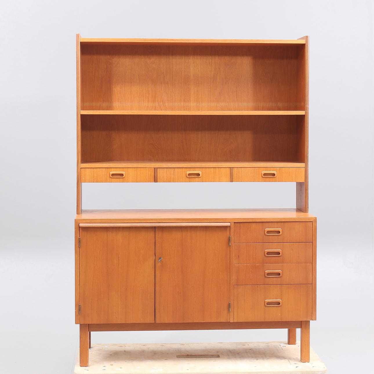 A teak bookcase with desk, 20th century.