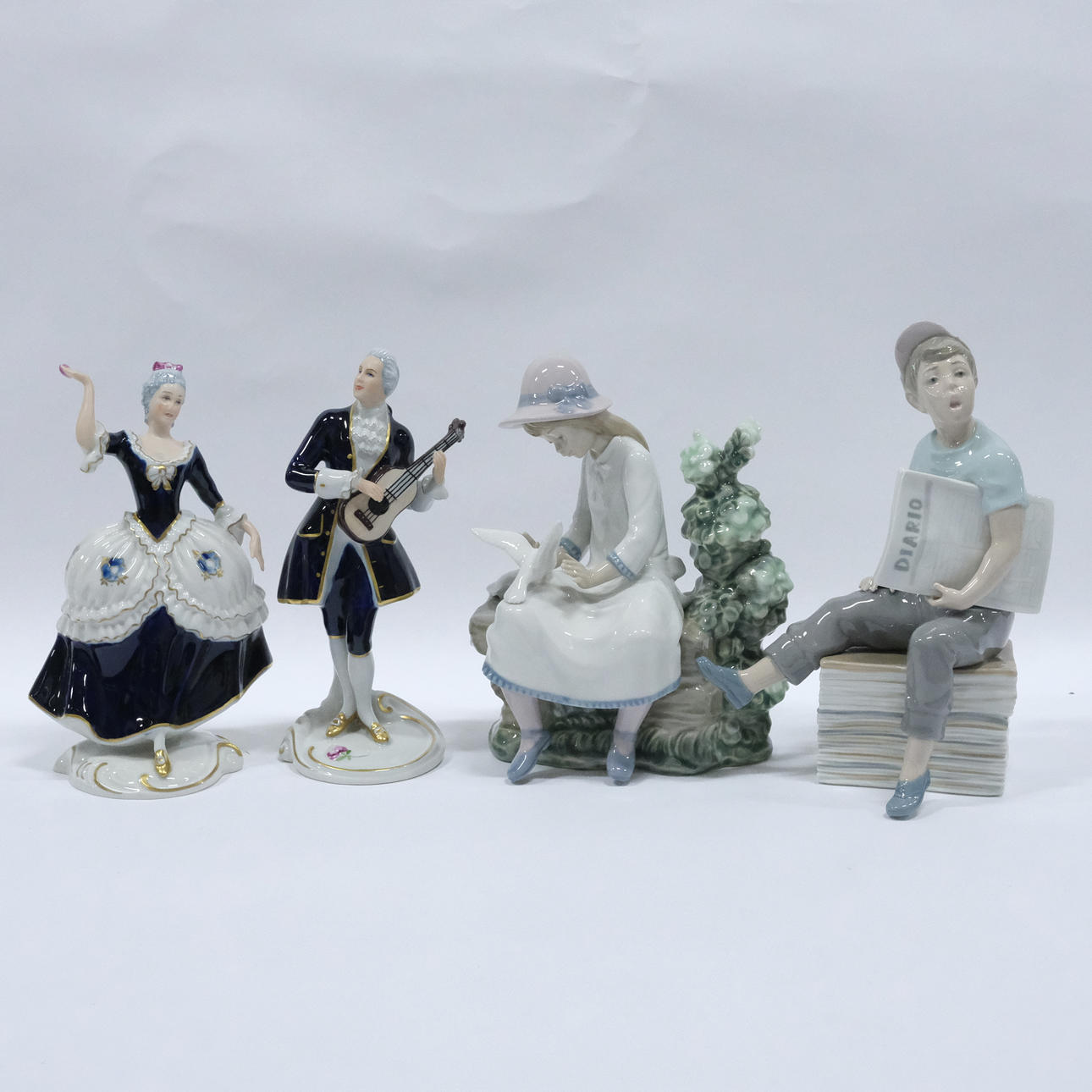 FOUR FIGURINES, ROYAL DUX AND NAO.
