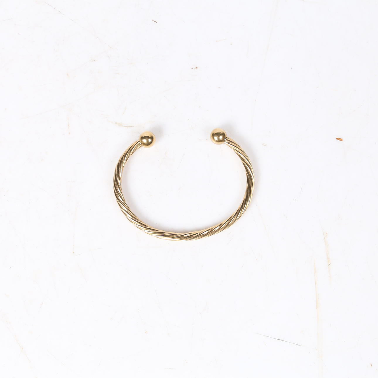 9CT GOLD TWISTED TORQUE BANGLE.