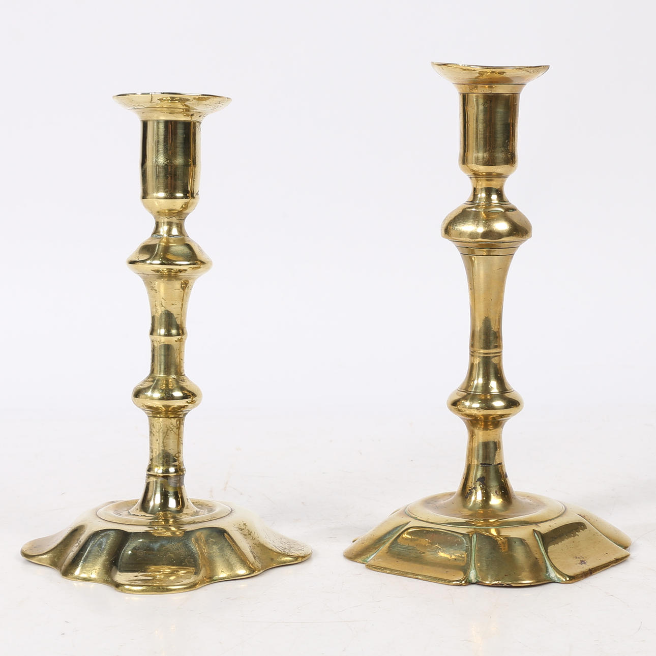 TWO GEORGE II BRASS CANDLESTICKS, CIRCA 1740-50.