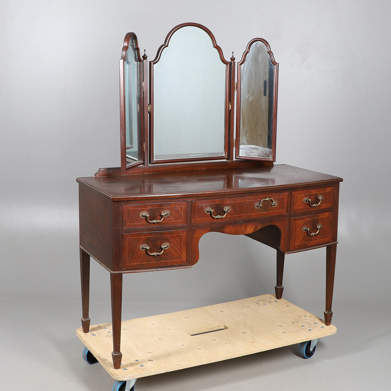 AN EDWARDIAN MAHOGANY BOW FRONT DRESSING TABLE.
