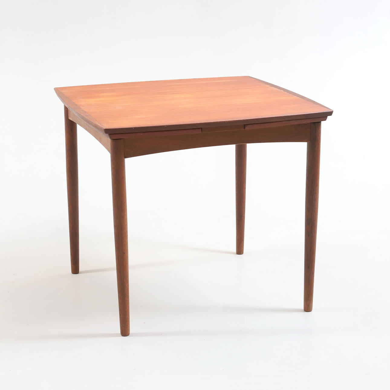 A dining table, teak, rounded legs, arched shape, Denmark, 1960s.