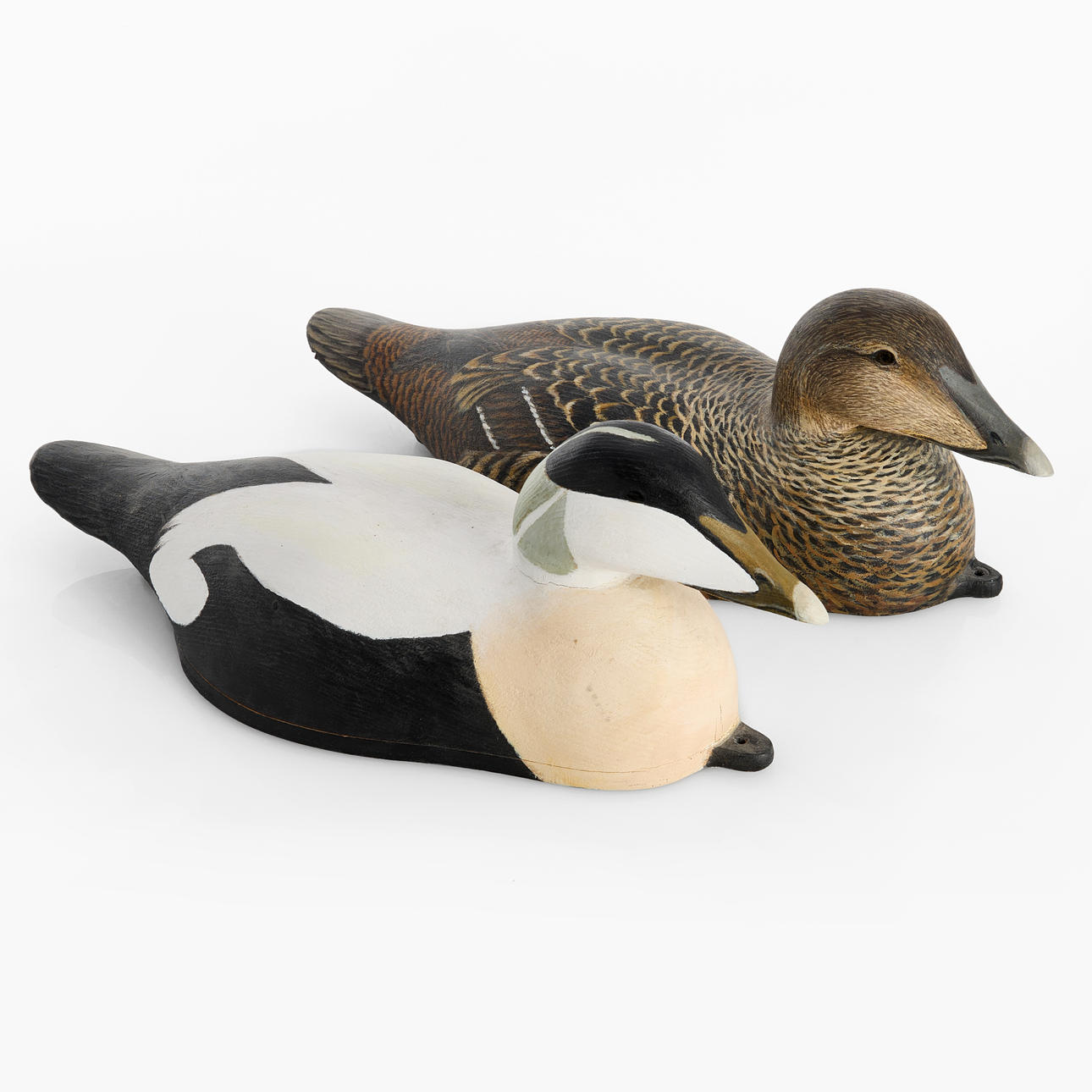 LARS-UNO ÖSTERMAN. Two painted wooden vettar, in the shape of an eidercock and a female (Guding and Åda), signed and dated Lars-U. Osterman 1993.