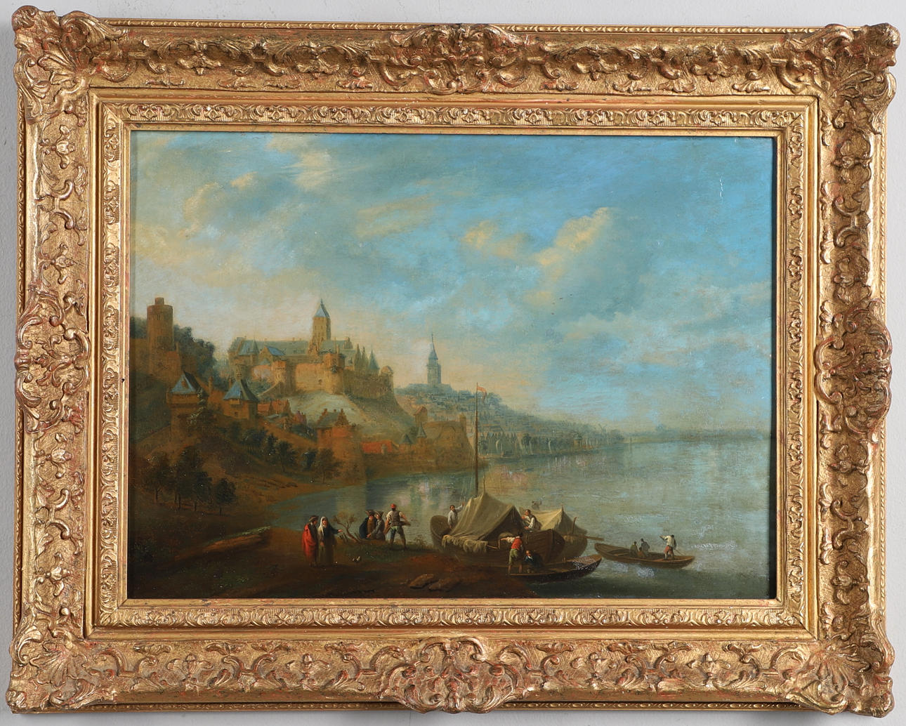 CIRCLE OF JAN FRANS VAN BREDAEL (1686-1750). FIGURES WITH BOATS ON THE EDGE OF A LAKE, A TOWN BEYOND.