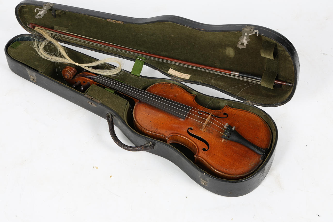 A VIOLIN AND BOW. CASE AND BRIDGE MARKED W. E. HILL & SONS.