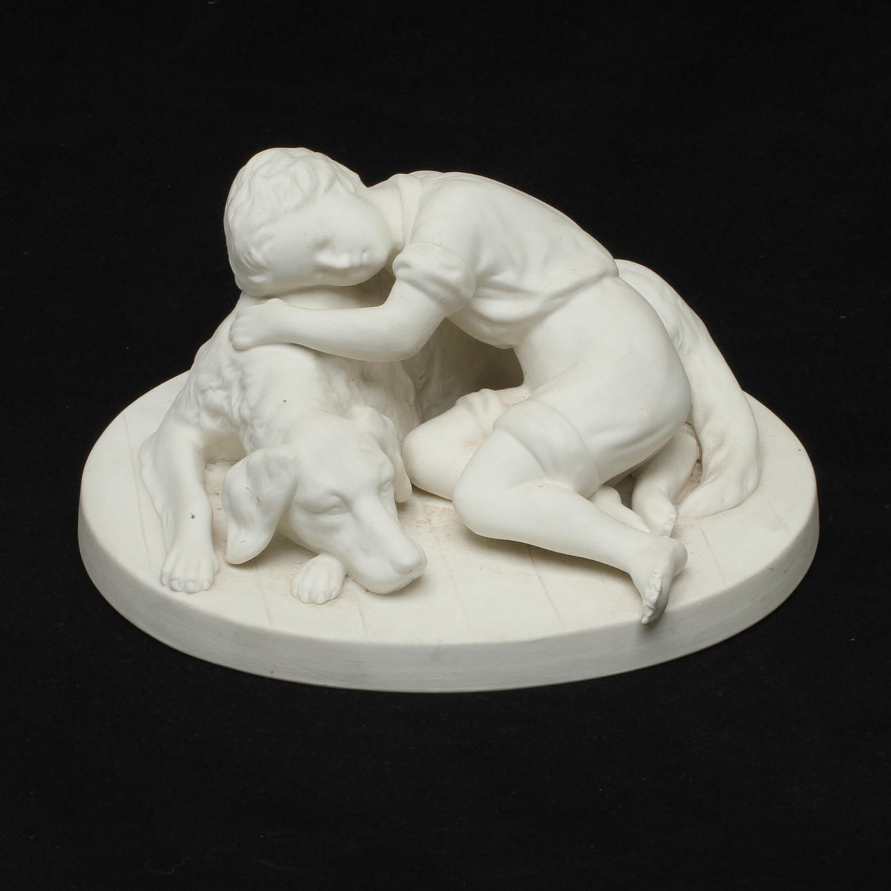 FIGURIN, parian, "Hund med pojke" efter A. Rudenschöld, Gustafsberg 1918.