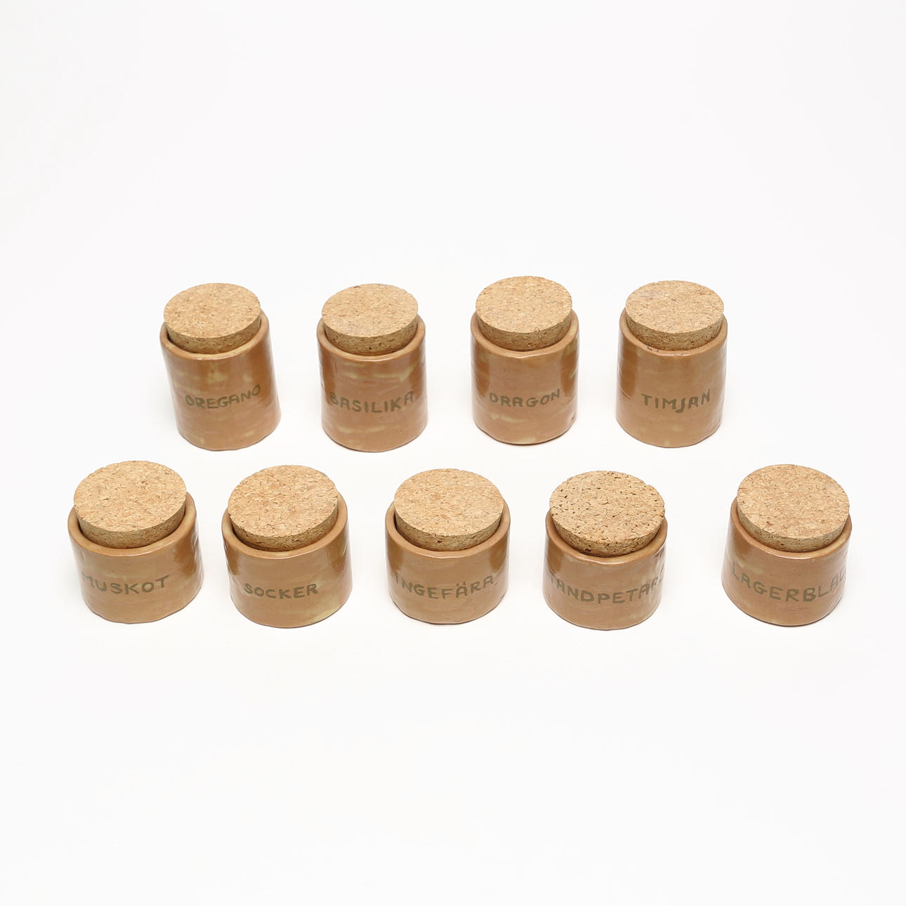 A set of 9 ceramic spice jars.