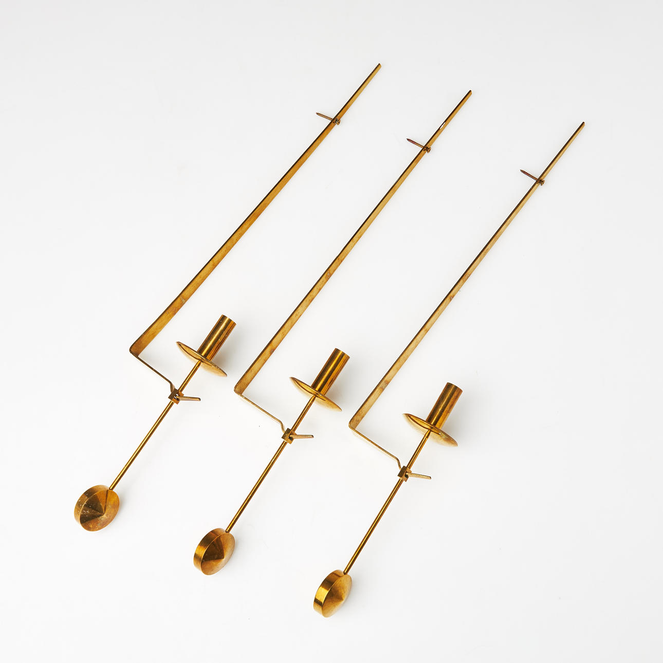PIERRE FORSELL. “Pendulum”, Skultuna, 3 wall sconces, brass.