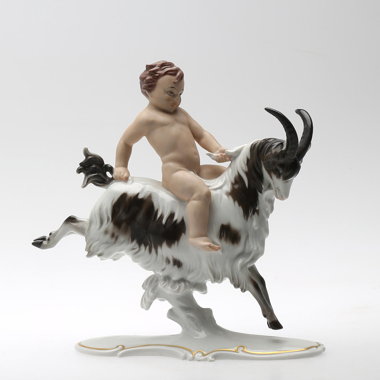 FIGURIN i porslin, Putti ridande på get, Märkt Rosenthal.