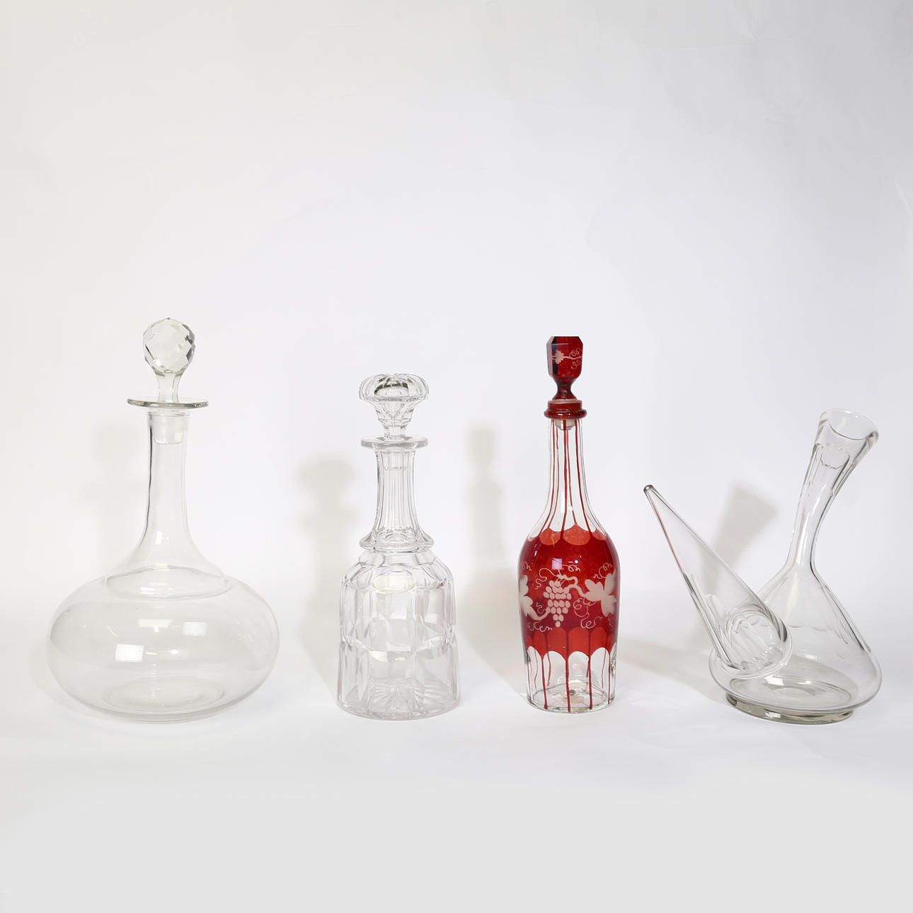 FOUR 19TH CENTURY AND LATER DECANTERS.