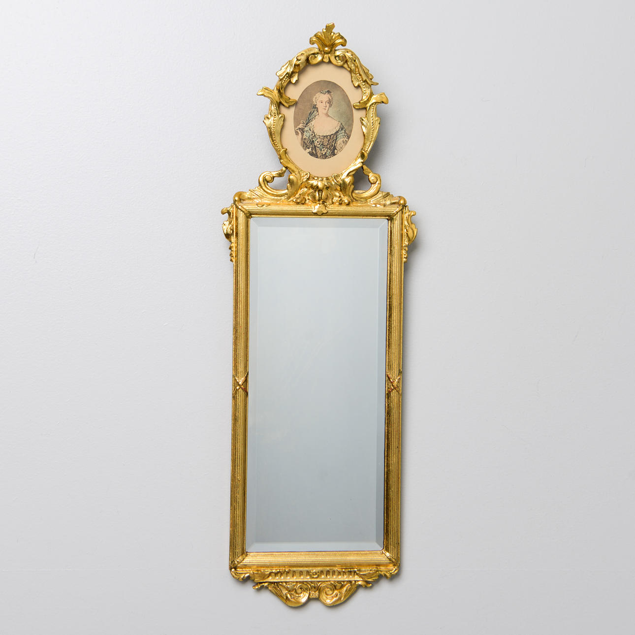 A 20th century rococo style mirror.