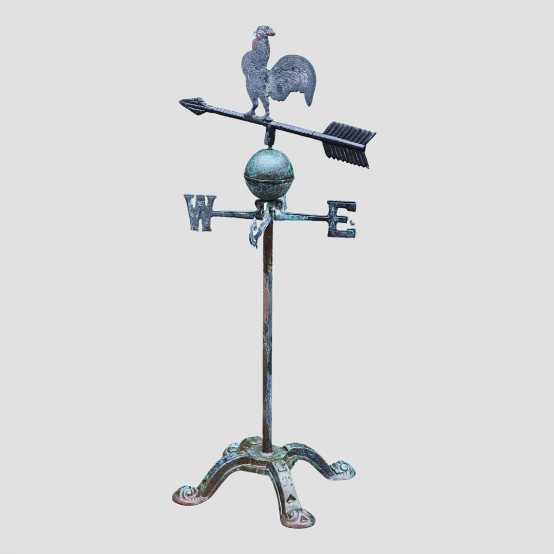 A FLOOR STANDING CAST IRON WEATHER VANE.