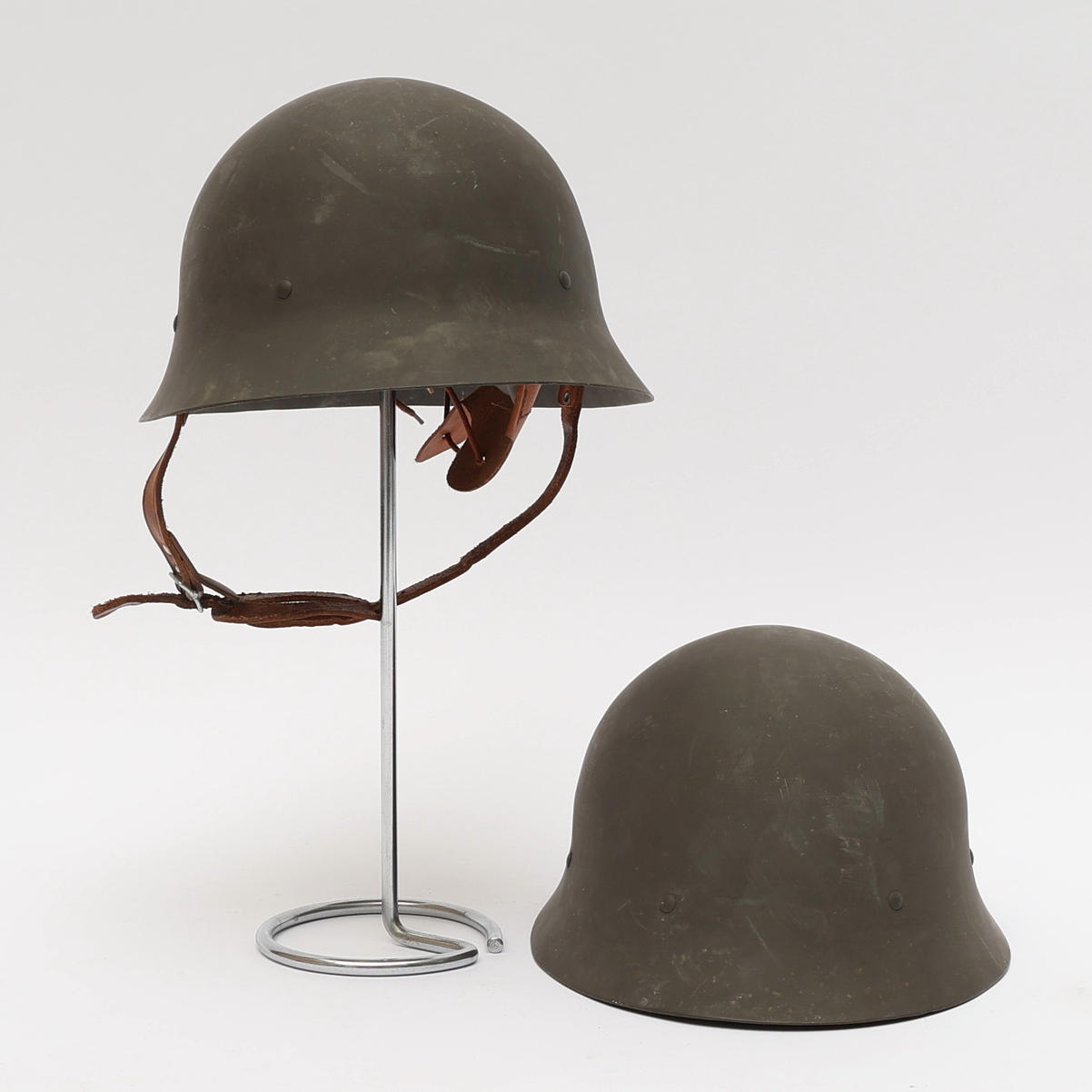 Two steel helmets, marked, 20th century.